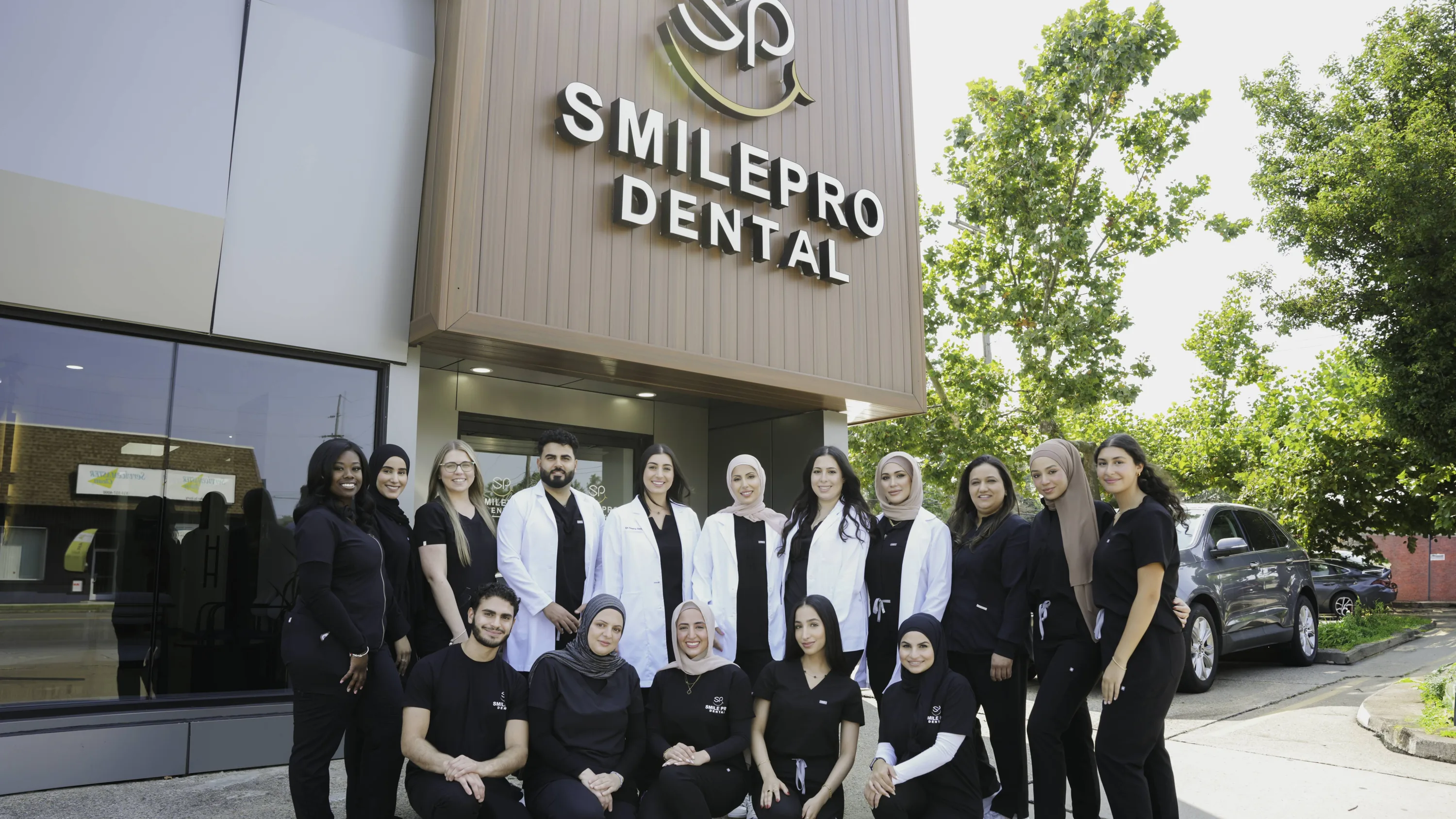 The SmilePro Dental team outside the practice on West Warren Avenue