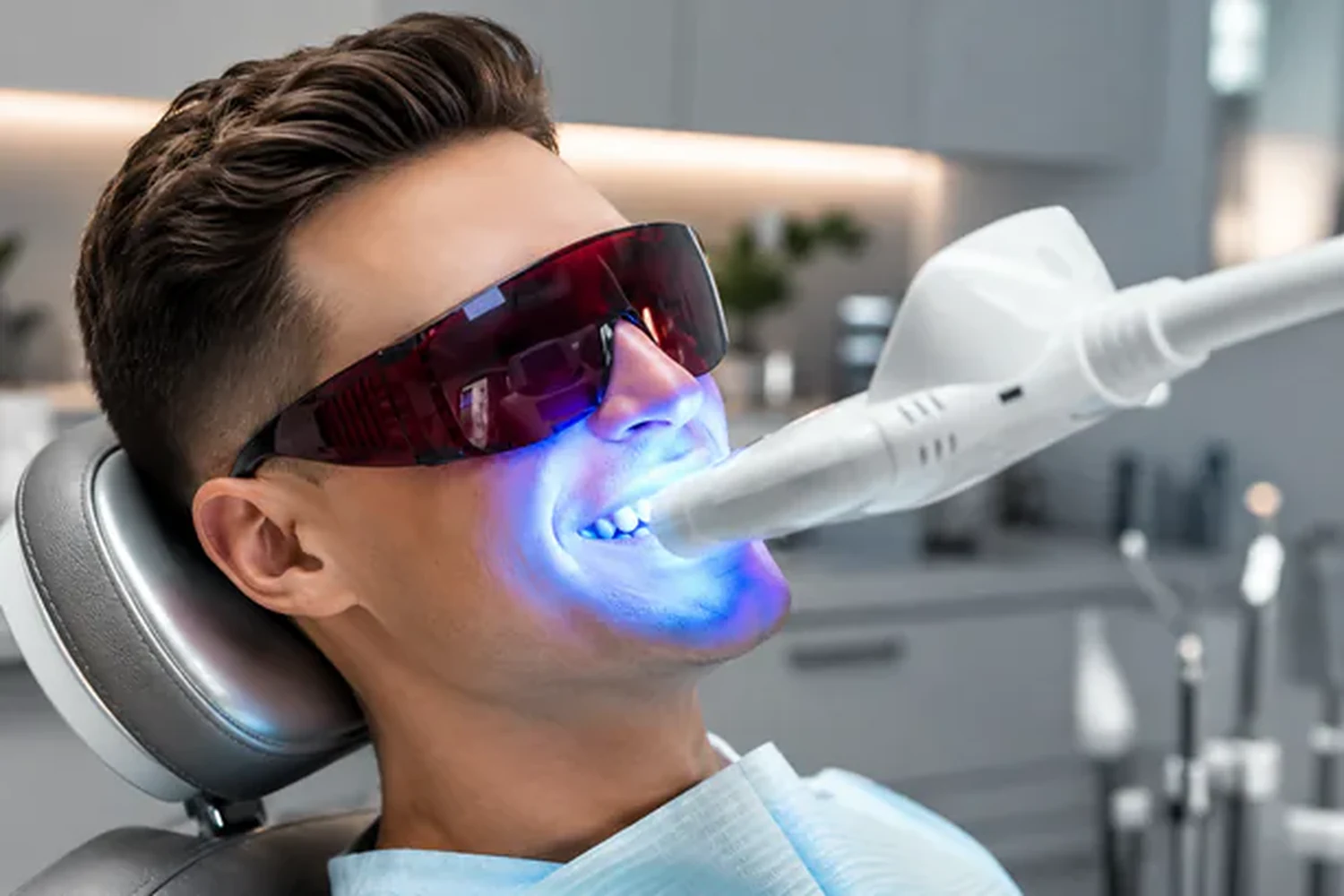 A patient under the in-chair whitening lamp during a Zoom whitening appointment